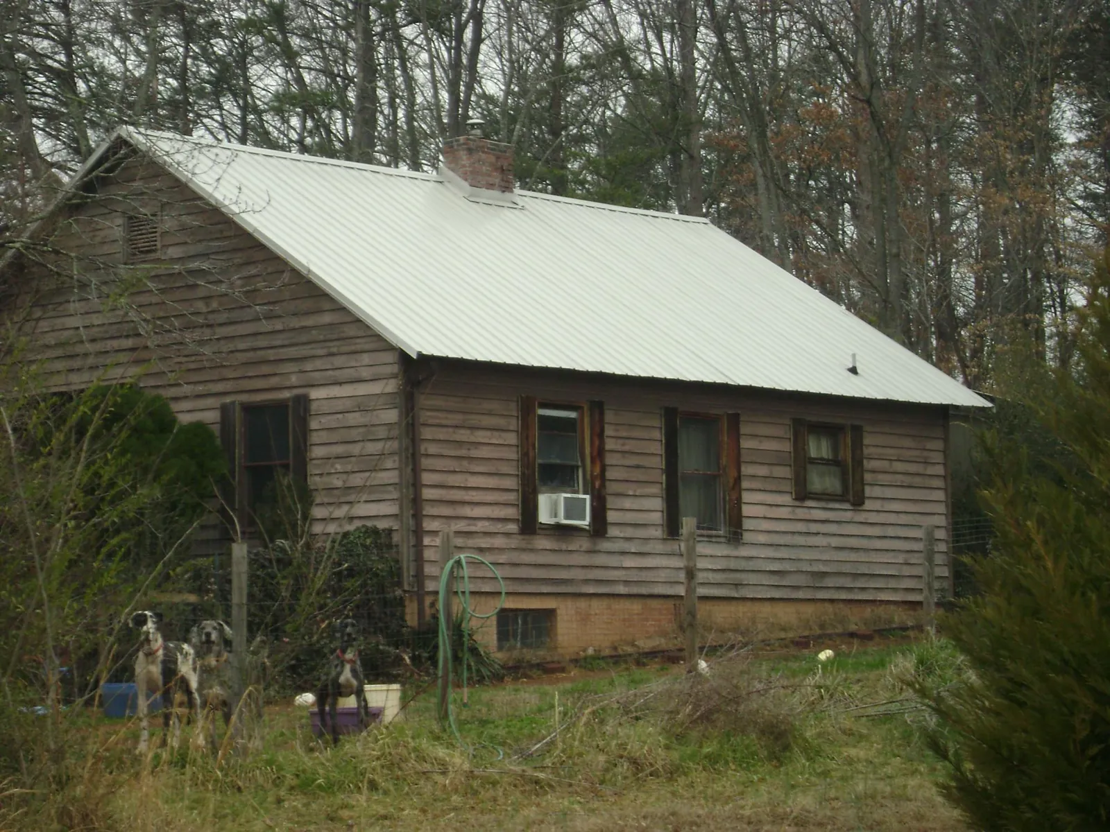 White metal roof on an old wood sided farmhouse, from a Metal Roof Installation job in Folly Beach